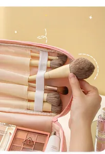Pink corduroy makeup bag detail showing 5 brush slots and elastic strap interior