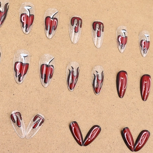 Red heart and black flame pattern press-on nails in long stiletto shape with glitter