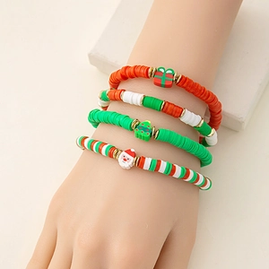 Wrist view of a 4-piece Christmas polymer clay bracelet set with festive holiday charms