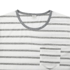 Close-up of the round neckline and chest pocket on a white and grey striped T-shirt