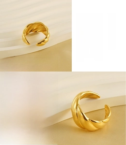 Detail of 18k gold plated stainless steel ring featuring twisted texture and lead-free material