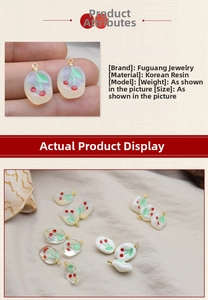 Detailed view of DIY resin cherry pendants with golden metal loops in three textures