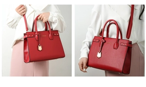 Detailed view of red textured PU leather handbag with gold metal logo and rivets
