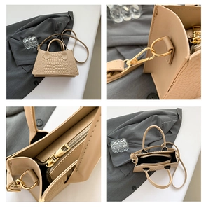 Detailsicht der beigen Handtasche mit Krokodilprägung, Metallzipper und Inneneinteilung