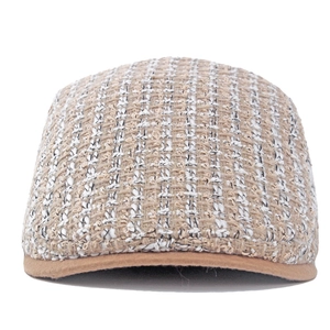 Dettaglio del berretto newsboy in tweed a quadri beige con bordo in pelle marrone