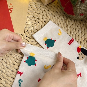 Close-up showing the high elasticity of Christmas socks with cute festive holiday patterns