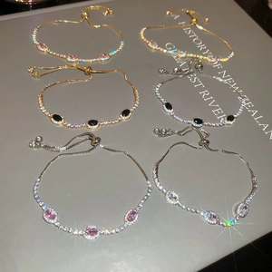 Close-up of adjustable zircon bracelets in gold and silver with oval stones