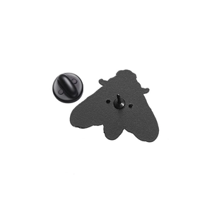 Detail view of moth-shaped black metal enamel pin back with secure rubber clutch fastener