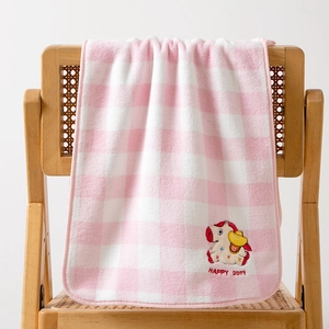 Detail showing soft coral fleece pink plaid towel with cute embroidered Happy Pony design
