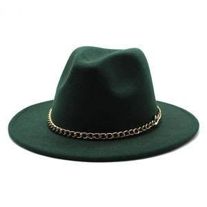 Detail of dark green wide brim fedora with decorative gold metal chain link