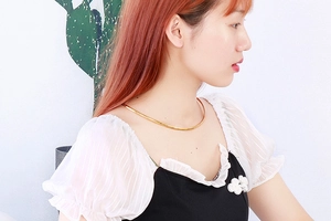 Detailed side view of a minimalist gold stainless steel rigid choker necklace on a model