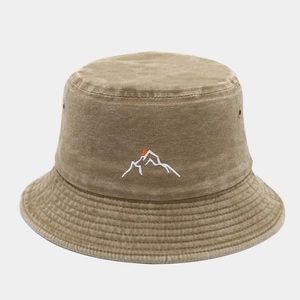 Detailed close-up of mountain sun embroidery on a washed canvas khaki bucket hat