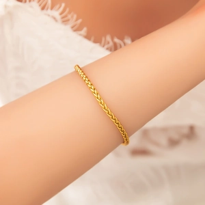 Elegant 18k gold plated stainless steel wheat chain bracelet worn on a woman wrist