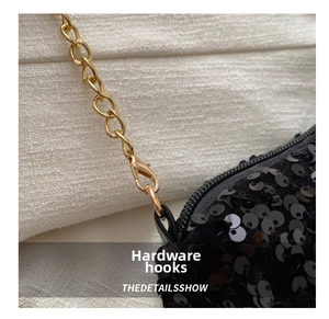 Macro shot of durable gold metal lobster hook and chain on black sequin bag