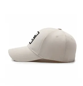 Side profile view of a beige baseball cap with black embroidered detail and curved brim