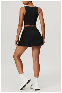 Back view of a black high-waist pleated sports skirt and matching slim-fit ribbed tank top
