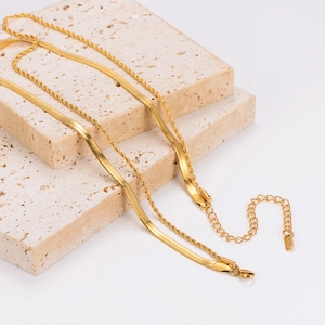 Elegant 18K gold layered necklace set with flat snake chain and twisted link chains