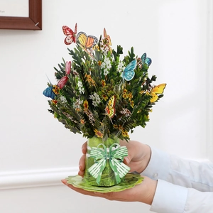 Detail of 3D pop-up flower card featuring colorful butterflies and a green paper bouquet