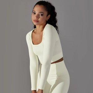 Detail of light yellow honeycomb textured seamless fabric on long sleeve yoga top