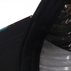 Close-up of double-stitched seams and transparent PVC material on black baseball cap