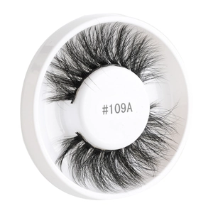 Detail view of 3D layered false eyelashes #109A in a circular white display tray