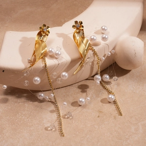 Detail of vintage gold leaf earrings with floral crystals and pearl tassel drops