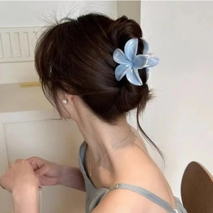 Blue marble plumeria flower hair claw clip on model's ponytail for elegant styling