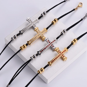 Cross charm bracelets in gold and silver with red and white zircons on black wax cords