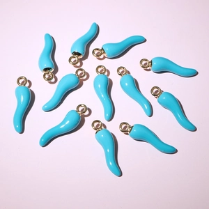 Sky blue enamel chili pepper charms for DIY jewelry on a soft pink background
