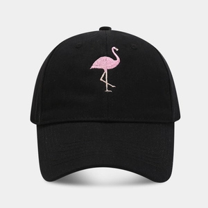 Close-up of pink flamingo embroidery on black cotton baseball cap with fine stitching