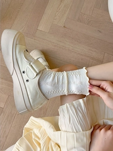Detailed close-up of beige JK calf socks featuring hollow patterns and ruffled lace trim