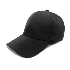 Detailed view of black baseball cap with wide curved brim and four precise stitching lines