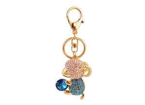 Close-up of golden sheep keychain featuring sparkling pink and blue crystals