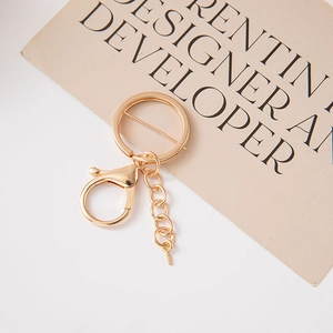 Golden alloy DIY keychain kit with lobster clasp flat ring and eye pin chain on white base