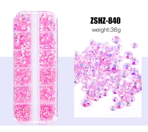 Pink AB resin nail art rhinestones in a 12-slot storage case with loose gems on the side