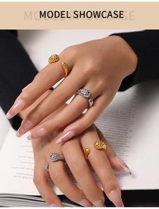 Close-up of hammered gold and silver irregular rings worn by a model in a fashion style
