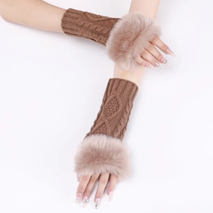 Detail of brown knit arm warmers with faux fur trim worn in a cross-arm pose