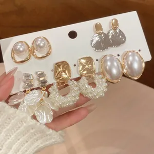 Elegant pearl and gold earring set featuring floral petals and minimalist stud designs
