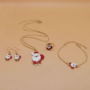 Macro view of a 4-piece gold metal jewelry set featuring Santa Claus enamel charms