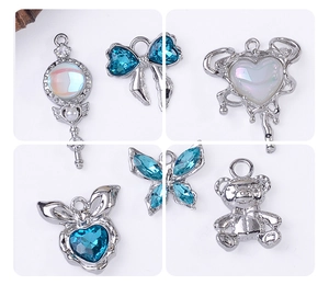 Macro detail of silver alloy charms with sky blue zircon and opal inlay for jewelry DIY