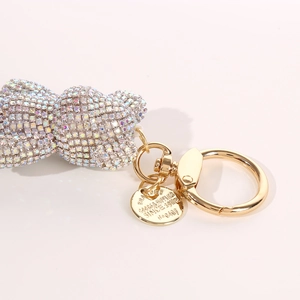 Detailed close-up of diamond-studded bear keychain with shiny gold hardware and tag