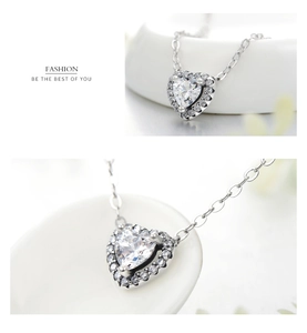Macro view of s925 silver heart pendant featuring large cubic zirconia and pave diamonds