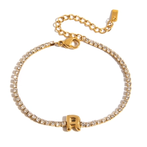 Close-up of 18K gold plated tennis bracelet featuring a cubic zirconia letter R charm