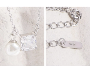 Macro detail of S925 silver necklace with white pearl and square zircon stone