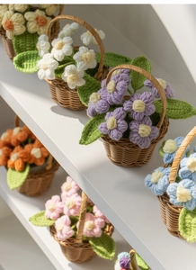 Close-up of colorful handmade crochet flower pots in mini woven baskets for home decor
