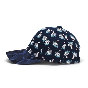 Navy baseball cap with white swan print and blue camouflage brim shown from a side view