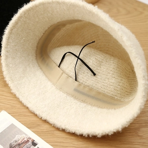 Off-white plush bucket hat with warm faux lamb wool and adjustable interior drawstring