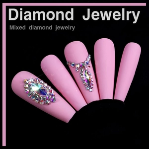 Detail of matte pink coffin nails with luxury mixed shaped crystal diamond jewelry patterns
