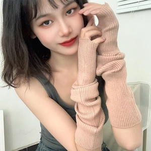 Pink knitted fingerless arm warmers with slouchy ribbed texture for a trendy look