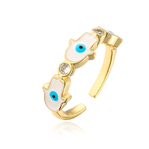 Detail of Hamsa Hand and Evil Eye gold ring with white enamel and sparkling zircons